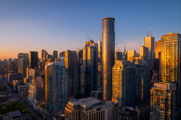 Toronto skyline reflecting golden sunrise over modern skyscrapers