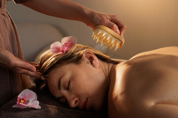 Relaxing Head Massage with Massager Tool for Stress Relief and Wellness in a Spa Setting