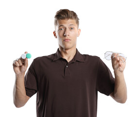 Man choosing between glasses and contact lenses on white background