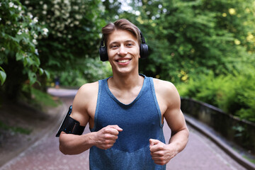 Sporty man with headphones running in park