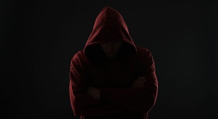 Anonymity. Man hiding his face in darkness