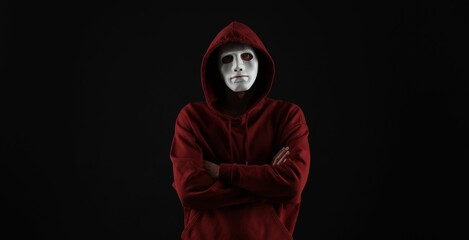 Anonymity. Man wearing mask on dark background