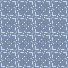 A geometric pattern composed of interlocking circles and diamonds is set against a dark gray background. The intricate design creates a sense of symmetry and repetition.
