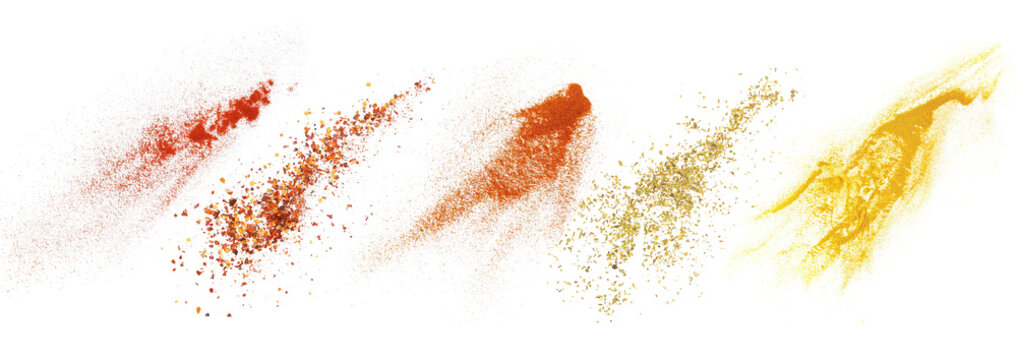 Red paprika powder, chili pepper flakes, chili red pepper ground, chopped oregano leaves and turmeric flying, isolated on white, clipping path