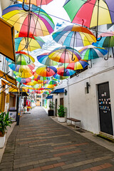 Colourful rainbow of umbrellas shade a laneway off Armenian St in George Town's heritage area. © kalama