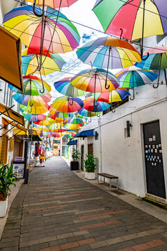 Colourful rainbow of umbrellas shade a laneway off Armenian St in George Town's heritage area.