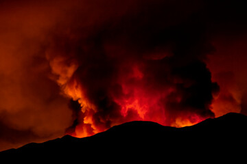Intense glow of a forest fire at night. The image is from the Holy Fire in August 2018