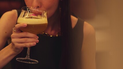 Closeup beautiful woman making a toast mixed passion fruit smoothie cocktail with friend holding...