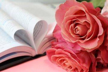 Pink roses and heart shaped book pages.