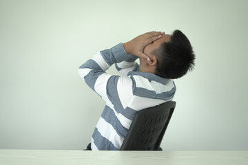 Young asian businessman suffering headache, backache and neck pain while working for so long,...