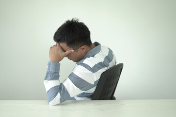Young asian businessman suffering headache, backache and neck pain while working for so long,...