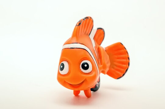 Plastic toy fish Nemo from animated film on white background