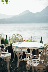 Beautiful cafe with empty chairs on Varenna waterfront on a sunny summer afternoon shoot during...