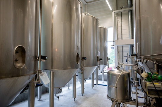 Stainless steel brewing tank inside modern craft brewery facility