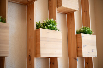 Wooden wall planter and boards are a decorative element in the interior.