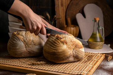 Healthy, organic, whole and sliced ​​homemade sourdough bread with ham and cheese on a wooden...
