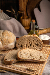 Healthy, organic, whole and sliced ​​homemade sourdough bread with ham and cheese on a wooden...