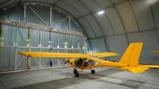 Yellow airplane glider in the hangar. 