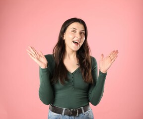 Portrait of surprised woman on pink background