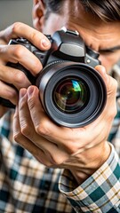 A close-up of a photographer’s hands adjusting the focus ring on a professional camera