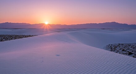 Serene sunset over White Sands National Park with gypsum dunes and distant mountains