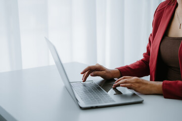 Crop shot of woman hand works on laptop Bookkeeper or financial inspector hands with copy space making the report and calculating. Home finances, investment, economy, or insurance concept