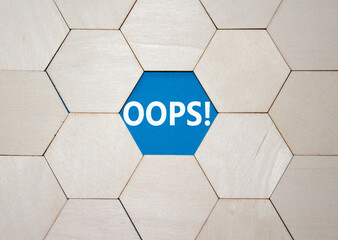 Oops symbol. Concept word Oops on wooden comb puzzle. Beautiful blue background. Business and Oops...