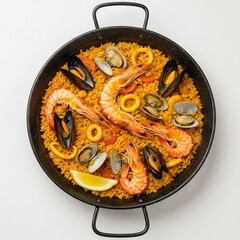 Traditional Spanish seafood paella cooked with rice, prawns, mussels, clams, and squid served in a black paella pan.