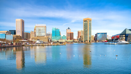 skyscrapers of Baltimore are reflected in the water of Inner Harbor, Maryland.