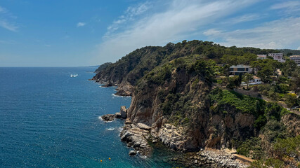 Scenic view of the Mediterranean Sea and the coastal town of Tossa de Mar in Catalonia, Spain. Historic architecture and natural beauty by the seaside.