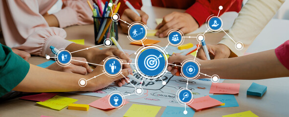 Creative business team brainstorming about marketing strategy and business plan by using mind mapping. Startup team work together to write down on paper. Focus on hand. Closeup. Variegated. Amity