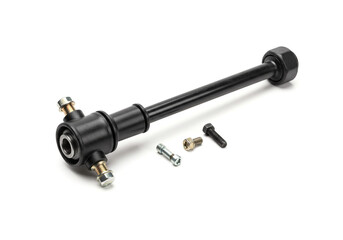 A black metal bar with bolts and screws on a white surface in a studio setting close up view