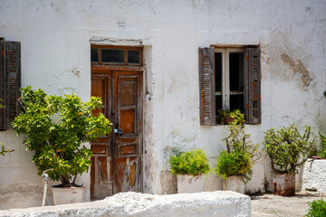Traditional Whitewashed House with Weathered Wooden Door and Shutters
