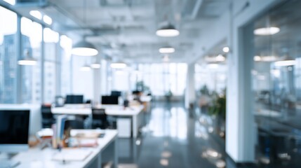 Blurred contemporary office space with desks, computers, and modern design elements creating a sense of openness and professionalism.