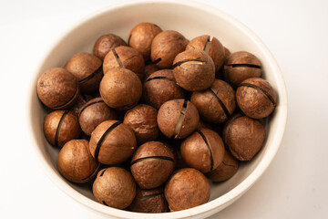 Macadamia nuts in a shell isolated on a white background.
