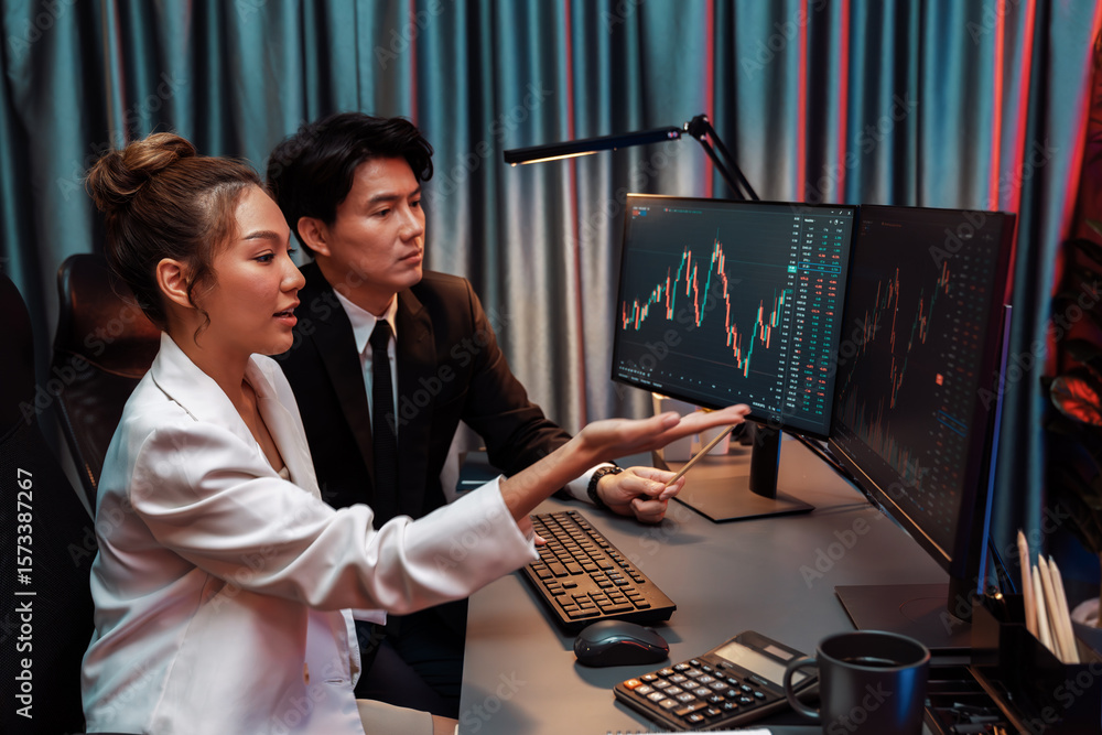 Poster smiling asian business traders pointing to dynamic stock exchange data screen profit value online we