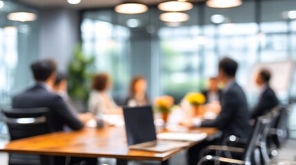 Fototapeta premium Blurred vision of business meeting with colleagues, laptop, office setting, and corporate environment representing teamwork and professionalism, leadership and management.