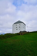 Fototapeta premium Historic white fortress on a green hill in Trondheim.