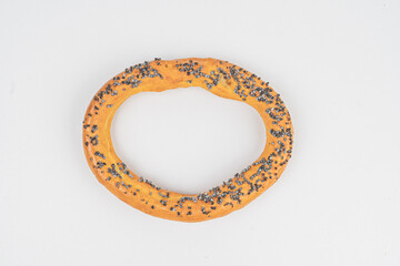Golden-brown ring-shaped pastry with poppy seeds, showcasing artisanal quality and enticing...