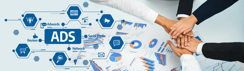 A dynamic collaboration scene showcasing hands united over analytical data in advertising,...
