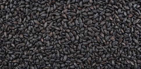 Obraz premium A mound of dark gray sunflower seeds, some cracked , texture, organic, snack