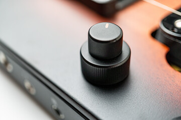 High-angle shot of a sleek, professional electric guitar pedal board with black potentiometers, showcasing craftsmanship and essential for music creation