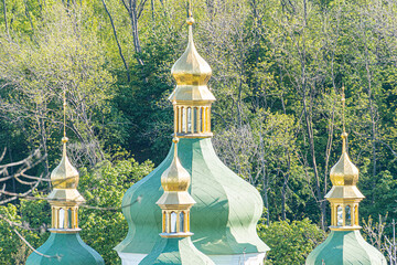 Traditional Russian Orthodox church with multiple domed onion-shaped roofs, golden crosses, dark...