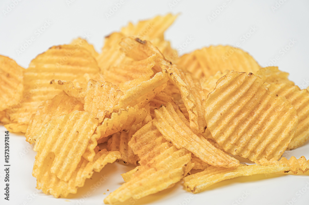 Poster close-up image of golden brown, crispy potato chips on neutral background varied textures with disti
