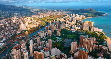 Beautiful cityscape of Honolulu at sunset time. Drone footage over Waikiki resort. Koko head crater at backdrop. - Powered by Adobe