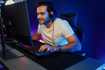 Serious face gaming streamer concentrating gaming players trying to pass at mission completed,...