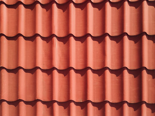 Red metal roof background. Roofing iron texture. Construction concept.