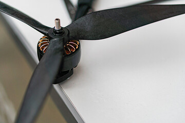 Close-up of black rotor blades and hub with yellow ball bearings, possibly part of a combat...