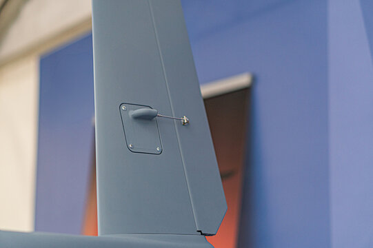 Aerial view of a single-engine propeller plane against cloudy sky, emphasizing motion and broad wings Gray structure contrasts with darker sky No additional objects or texts