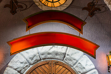 Christmas clock tower interior, traditional Irish pub setting, red and gold decorative sign, warm ambient lighting, stone walls with soft shadows, elaborate ceiling design, wooden door in stone wall,